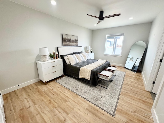 bedroom with ceiling fan and light wood-type flooring
