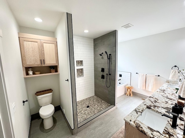 full bathroom featuring plus walk in shower, hardwood / wood-style floors, vanity, and toilet