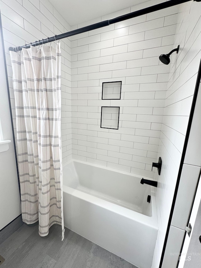 bathroom with wood-type flooring and shower / bath combo with shower curtain