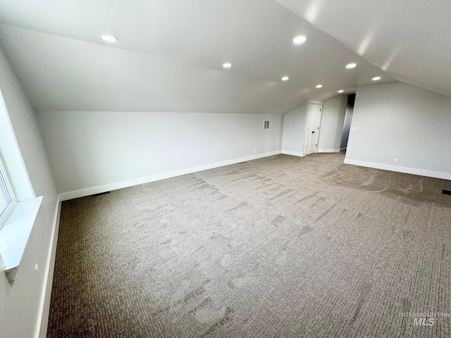 additional living space with lofted ceiling and carpet floors