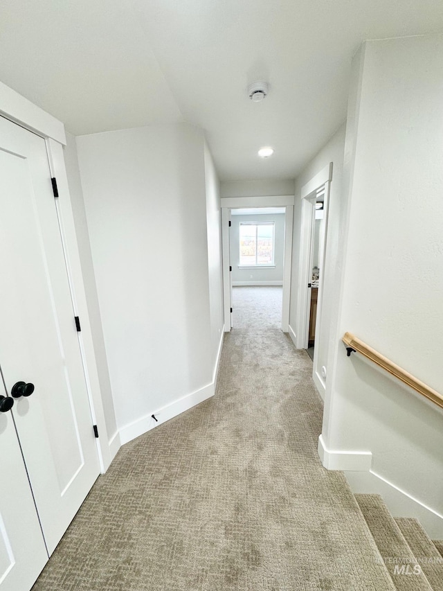 hallway featuring light carpet