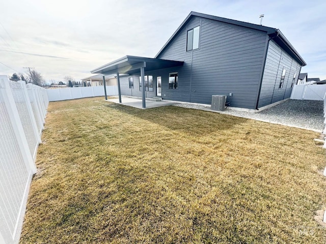 rear view of house featuring a patio, cooling unit, and a lawn