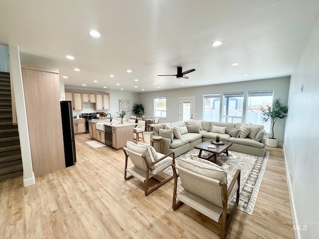 living room with sink and light hardwood / wood-style floors