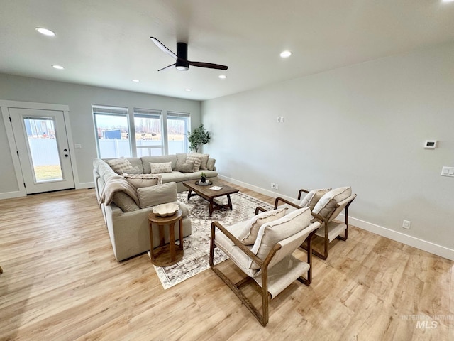 living room featuring ceiling fan and light hardwood / wood-style flooring