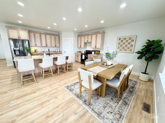 dining space with light wood-type flooring