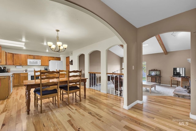 dining room with beam ceiling, an inviting chandelier, light wood-style flooring, and baseboards