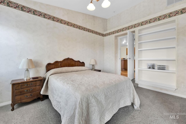 carpeted bedroom featuring wallpapered walls, visible vents, and baseboards