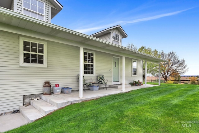 view of exterior entry with a lawn