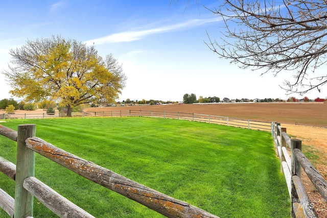 view of yard featuring a rural view and fence