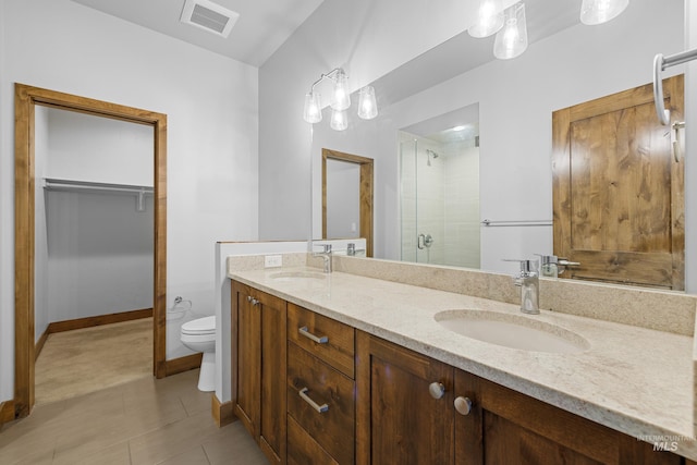 bathroom featuring walk in shower, tile patterned floors, vanity, and toilet