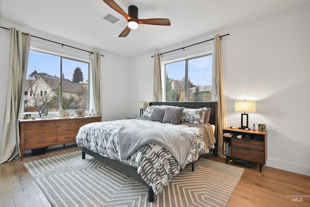 bedroom with light wood-type flooring and ceiling fan