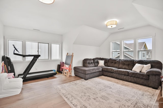 living room with vaulted ceiling and light hardwood / wood-style flooring