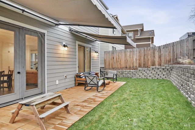 view of yard with french doors and a patio