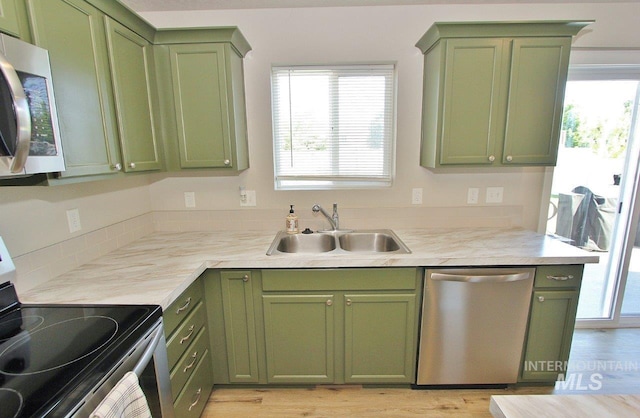 10382 Scout Ridge St, Nampa, ID 83687 - kitchen featuring green cabinetry, appliances with stainless steel finishes, a sink, and healthy amount of natural light