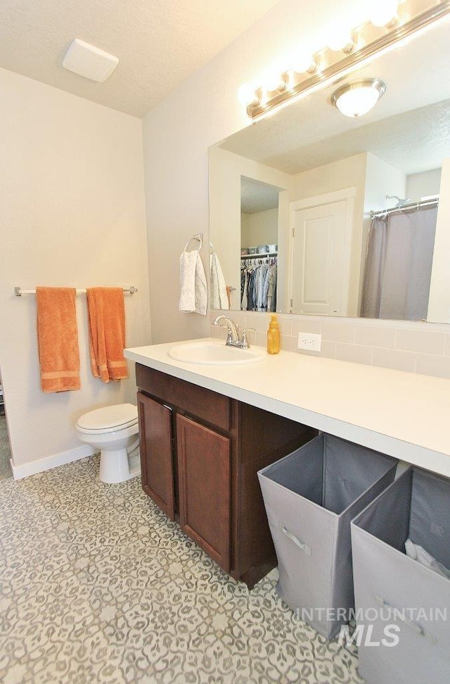10382 Scout Ridge St, Nampa, ID 83687 - bathroom with vanity, toilet, tile patterned floors, and baseboards