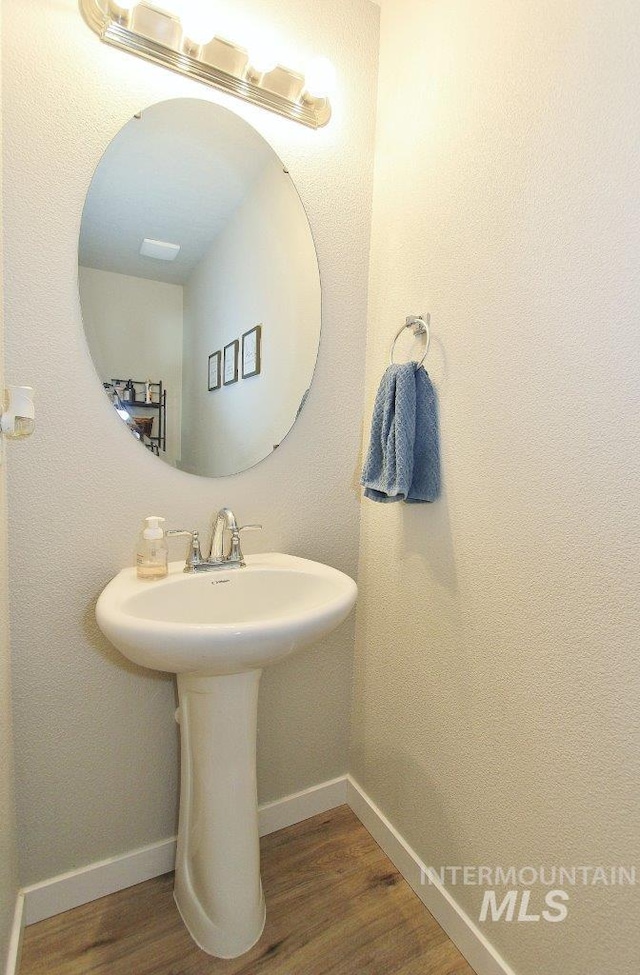 10382 Scout Ridge St, Nampa, ID 83687 - bathroom with wood finished floors, baseboards, and a sink