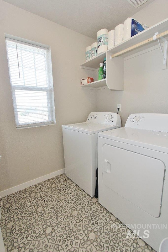 10382 Scout Ridge St, Nampa, ID 83687 - laundry area with washing machine and dryer, baseboards, and light floors
