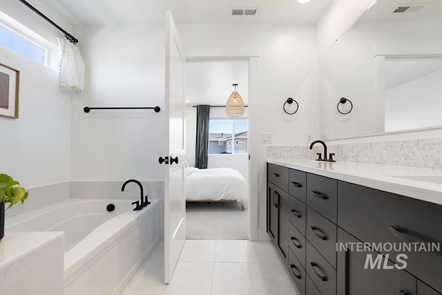 12524 W Shortcreek, Star, ID 83669 - bathroom with double vanity, a garden tub, healthy amount of natural light, and tile patterned flooring