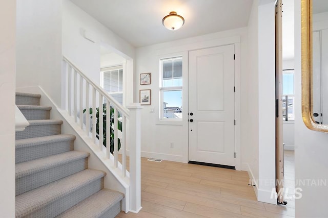 12524 W Shortcreek, Star, ID 83669 - entrance foyer with light wood-style flooring, stairs, and healthy amount of natural light