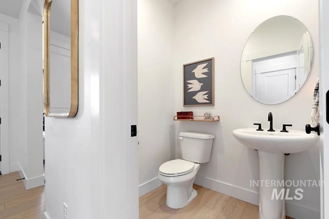 12524 W Shortcreek, Star, ID 83669 - half bathroom featuring toilet and wood finished floors