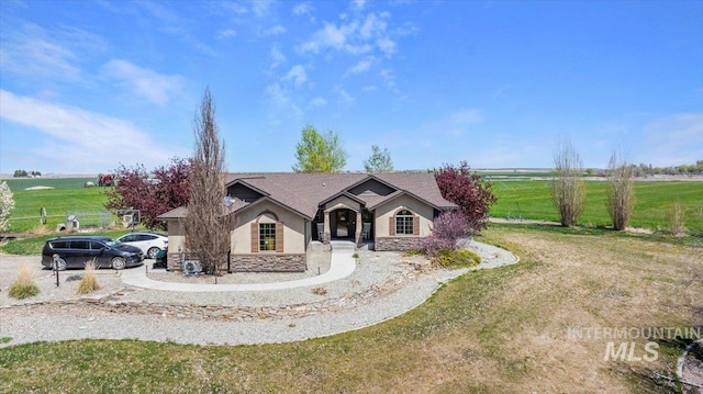 23 N 950 E, Declo, ID 83323 - view of front facade featuring a front lawn, stone siding, and stucco siding