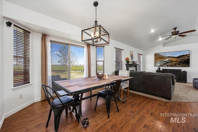 23 N 950 E, Declo, ID 83323 - dining area with dark wood-style flooring, a fireplace, baseboards, ceiling fan with notable chandelier, and lofted ceiling