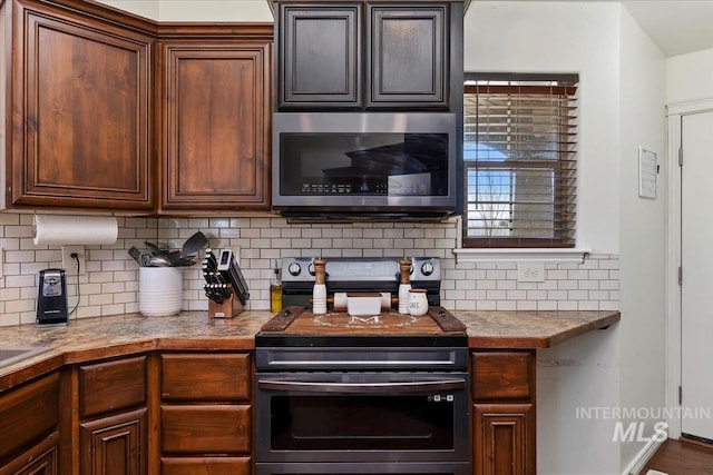 23 N 950 E, Declo, ID 83323 - kitchen featuring light countertops, stainless steel appliances, and decorative backsplash