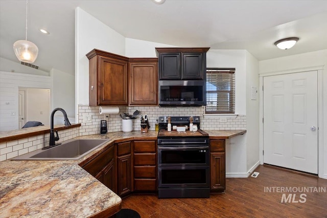 23 N 950 E, Declo, ID 83323 - kitchen featuring a sink, stainless steel microwave, double oven range, lofted ceiling, and visible vents