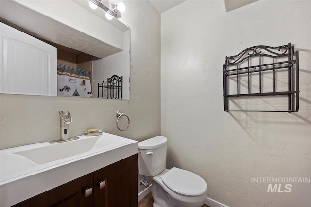 23 N 950 E, Declo, ID 83323 - bathroom with toilet, baseboards, a textured wall, and vanity