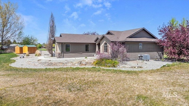 23 N 950 E, Declo, ID 83323 - rear view of property featuring a storage shed, central air condition unit, an outdoor structure, and a yard