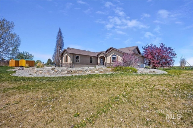 23 N 950 E, Declo, ID 83323 - ranch-style house featuring a storage shed, stone siding, an outbuilding, and a front yard