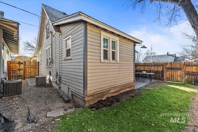 view of property exterior with a patio area, a lawn, cooling unit, and fence private yard