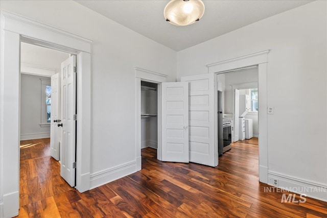 bedroom featuring baseboards and dark wood-type flooring