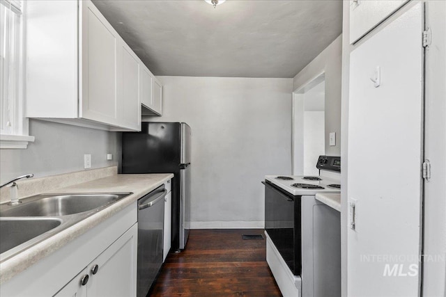 kitchen featuring electric stove, a sink, stainless steel dishwasher, white cabinetry, and dark wood-style flooring