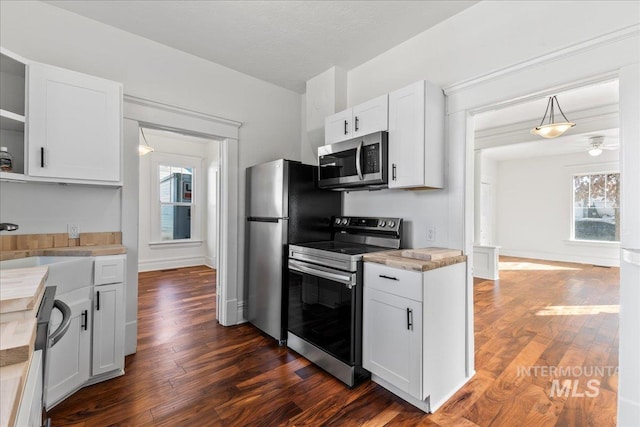 kitchen with open shelves, a wealth of natural light, dark wood-style flooring, and appliances with stainless steel finishes