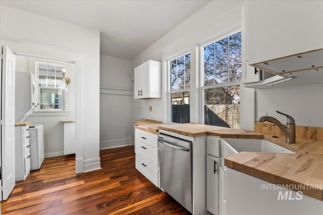 kitchen featuring butcher block countertops, a sink, stainless steel dishwasher, dark wood finished floors, and white cabinetry