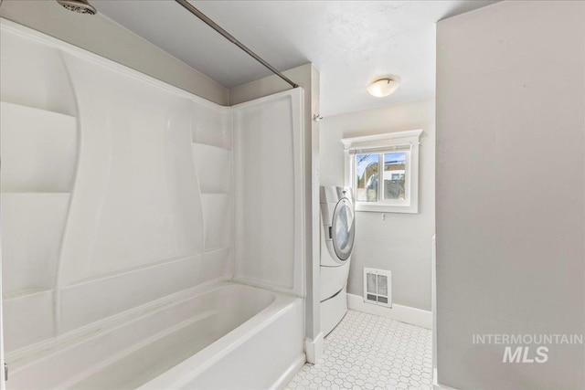 full bath featuring washer and dryer, baseboards, visible vents, and shower / bathtub combination