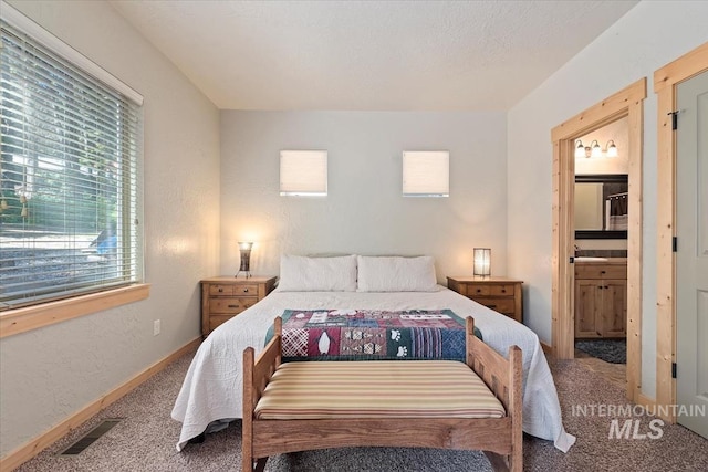 23 Waterline Ln, Cascade, ID 83611 - carpeted bedroom featuring connected bathroom and baseboards