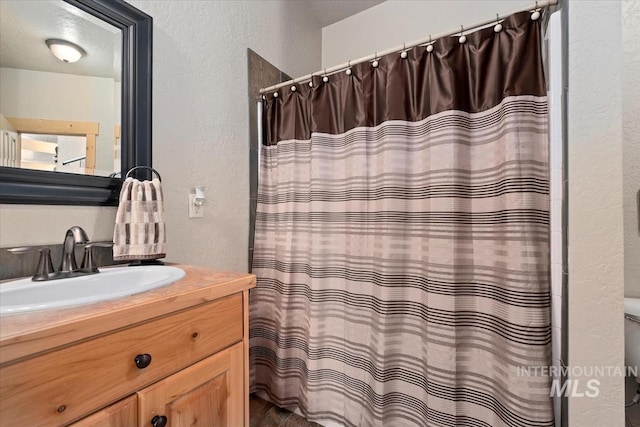 23 Waterline Ln, Cascade, ID 83611 - full bathroom with a textured wall, vanity, and a shower with curtain