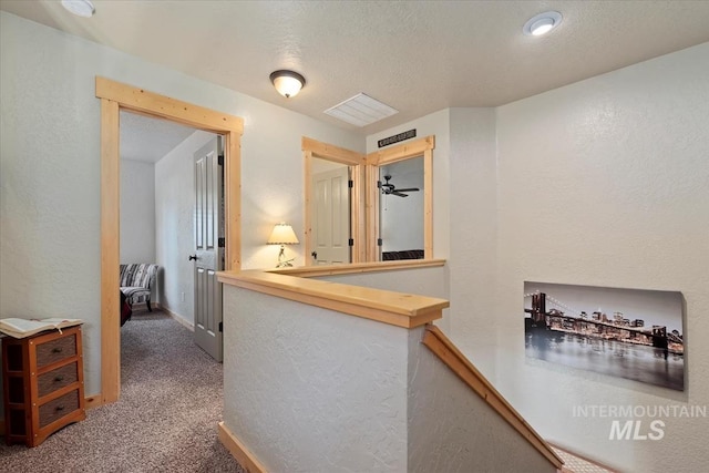 23 Waterline Ln, Cascade, ID 83611 - hallway featuring a textured wall, carpet flooring, and an upstairs landing