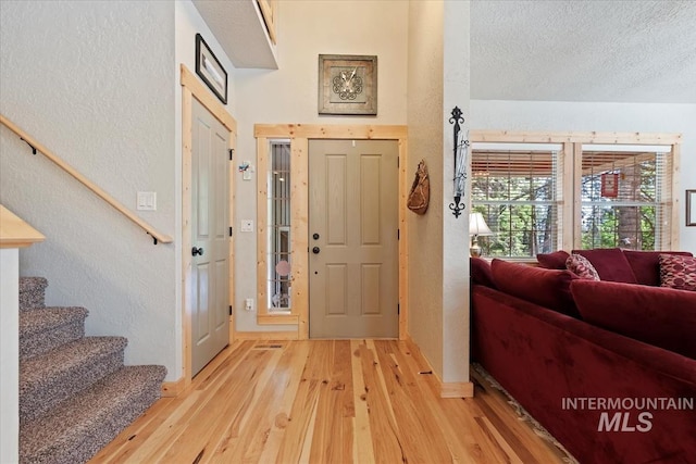 23 Waterline Ln, Cascade, ID 83611 - entryway featuring light wood finished floors, stairs, a textured wall, and a textured ceiling