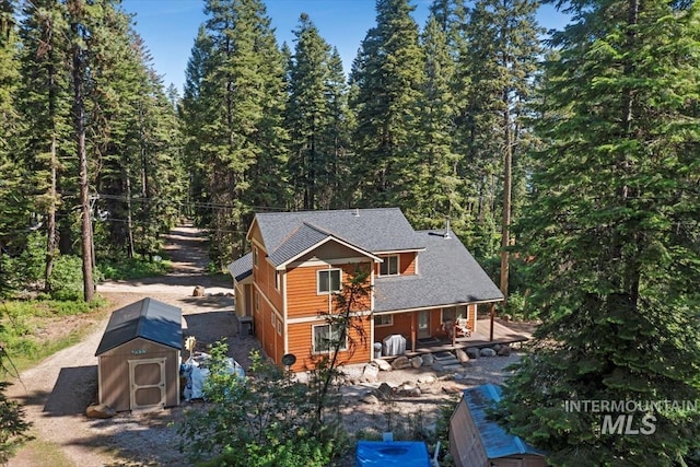 23 Waterline Ln, Cascade, ID 83611 - rear view of property with a storage shed, a porch, and a forest view