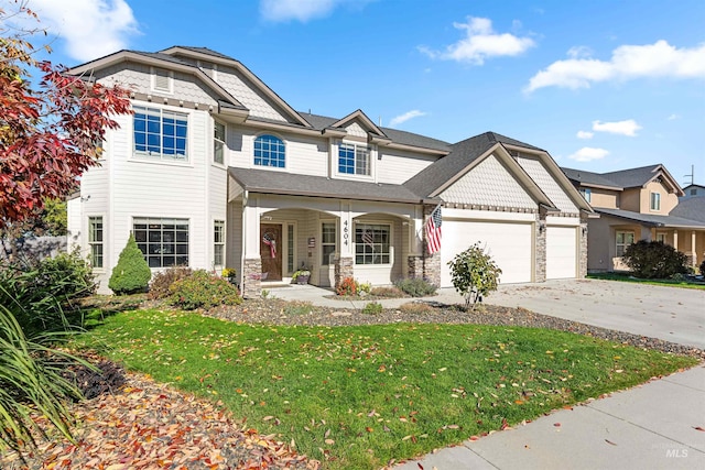 view of front of house with a porch, a front yard, a garage, stone siding, and driveway