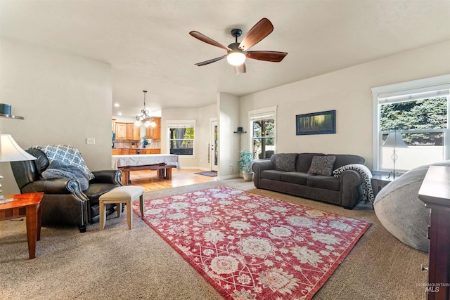 living room featuring ceiling fan and baseboards