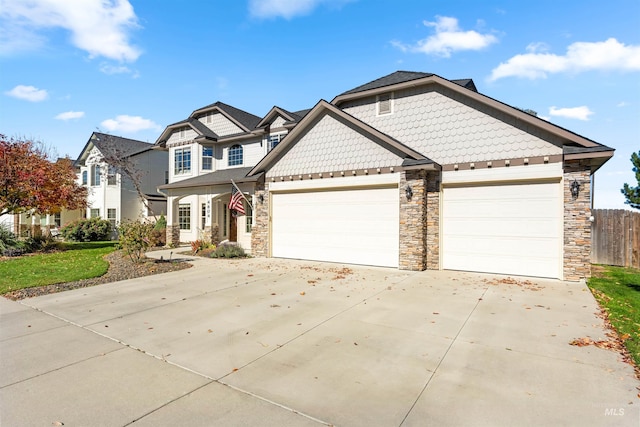 view of front facade with concrete driveway, fence, and an attached garage