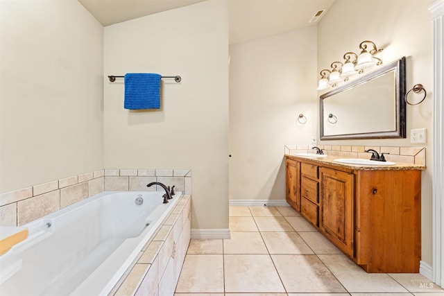 bathroom with double vanity, tile patterned flooring, a sink, and a bath