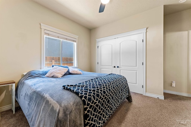 bedroom featuring ceiling fan, a closet, carpet flooring, and baseboards