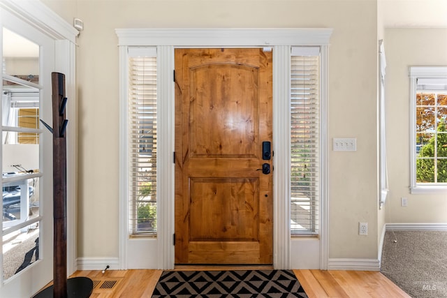 entrance foyer with light wood-type flooring and baseboards