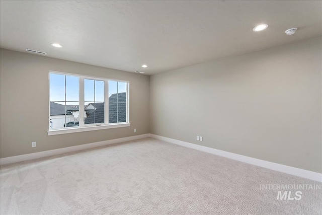 11966 W Zamalek Ct, Kuna, ID 83634 - empty room with light colored carpet, a smoke detector, and recessed lighting