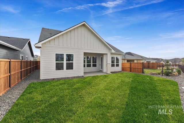 11966 W Zamalek Ct, Kuna, ID 83634 - back of house with board and batten siding, a fenced backyard, a patio area, and a shingled roof